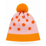 Pink beanie with orange polka dots and pom-pom on a white background
